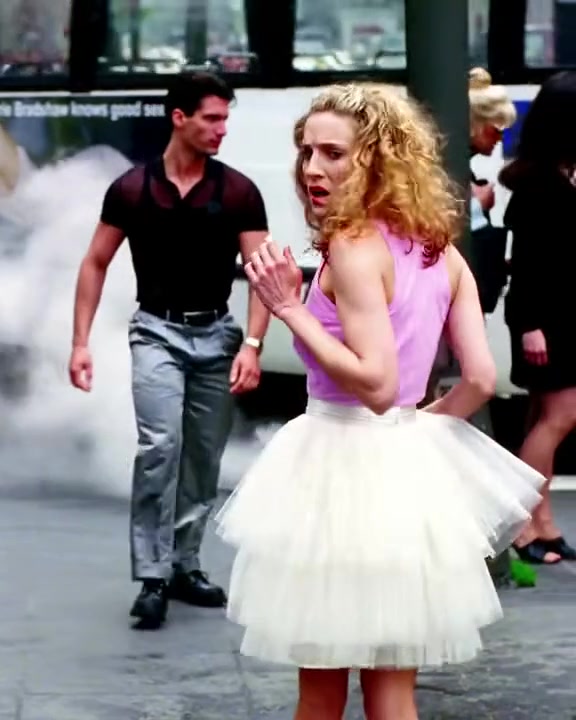 Carrie Bradshaw in a white tulle tutu skirt on a New York street, Sex and the City opening credits