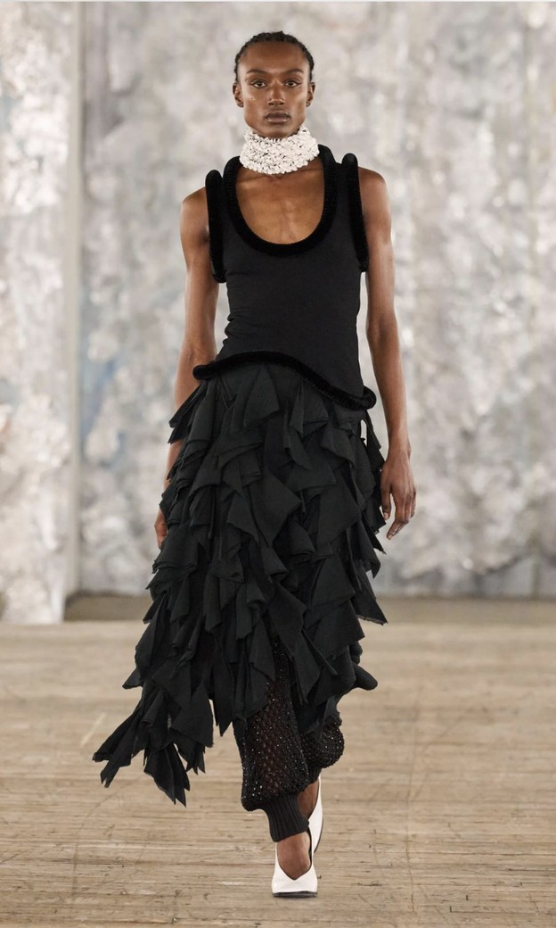 Eckhaus Latta Spring 2027: black tank top and a black skirt covered in rows of jagged ruffles