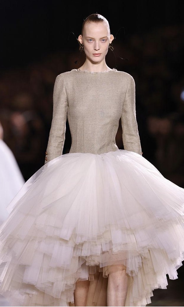 Blumarine Spring 2026: beige fitted bodice over a huge white tulle skirt of many layers, longer at the back