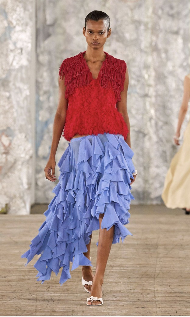 Roksanda Spring 2027: red fringed top and a periwinkle blue asymmetric skirt covered in rows of ruffles