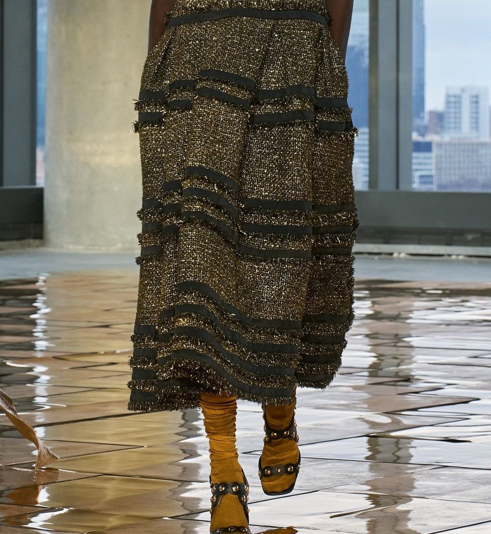 Close-up: gold-shot tweed tiers with fringed seams, Ulla Johnson Fall 2025