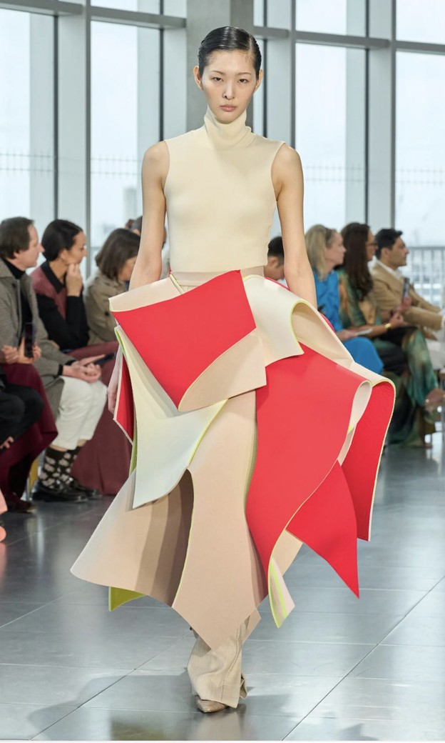 Roksanda Spring 2027: cream top and a sculptural skirt of stiff cream and red panels laid over each other like petals