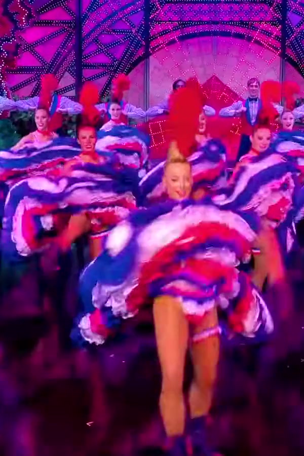 Cancan dancers at the Moulin Rouge today, swirling skirts lined with rows of blue, white and red ruffles