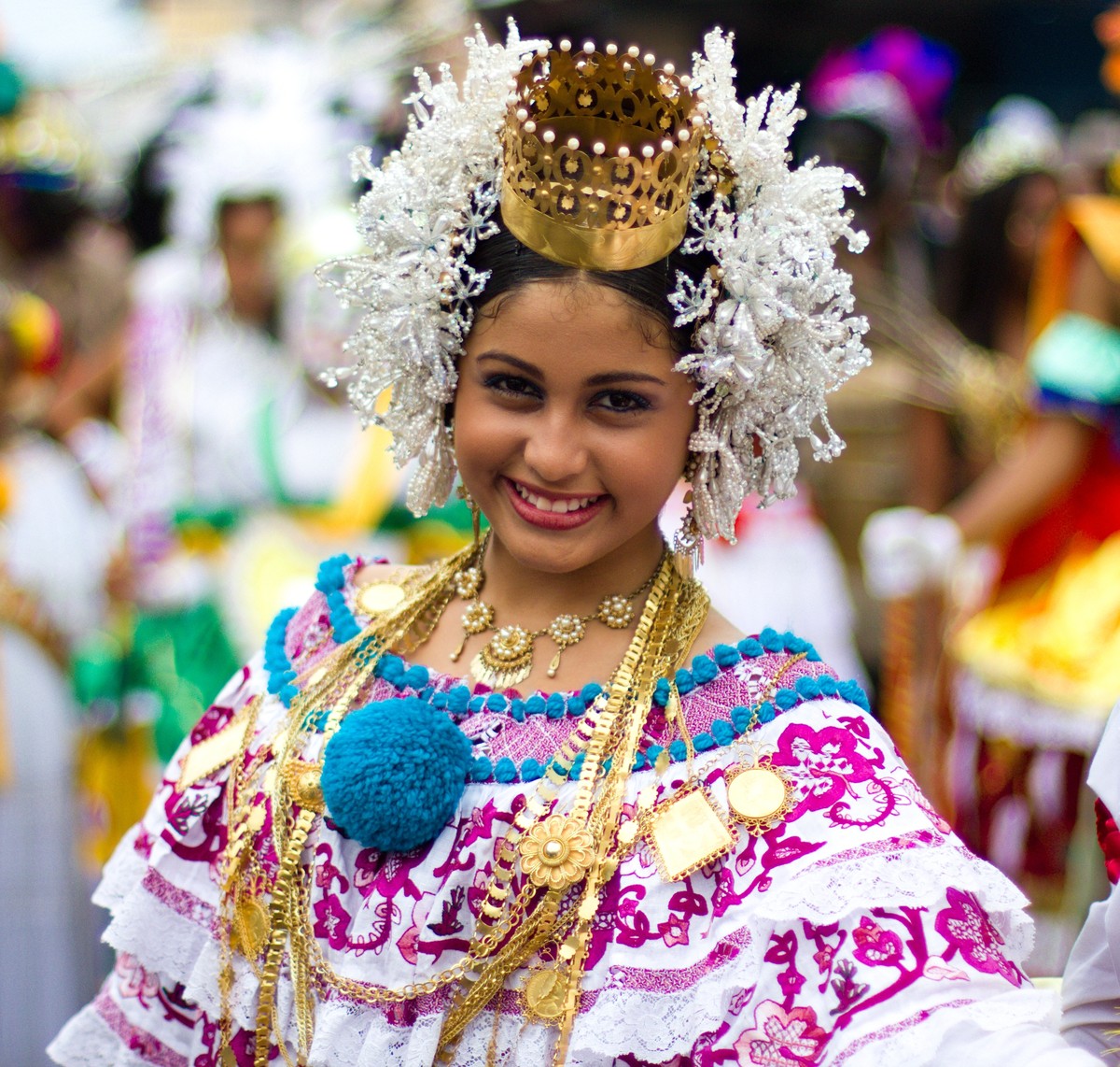 A young woman in a pollera with a crown-comb, white trembling hair ornaments called tembleques, wool pompoms and several gold chains, Chitré, 2012