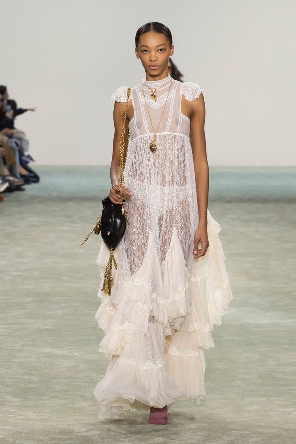 Chloé Fall 2025, look 12: ivory lace dress with a skirt of overlapping sheer ruffles