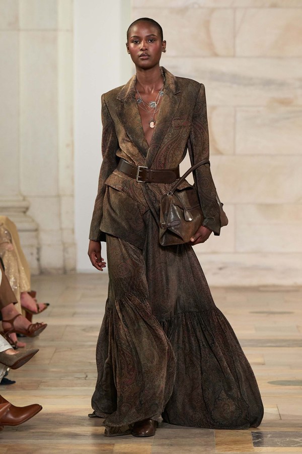 Ralph Lauren Fall 2025, look 18: brown jacket over a printed prairie maxi skirt with gathered tiers