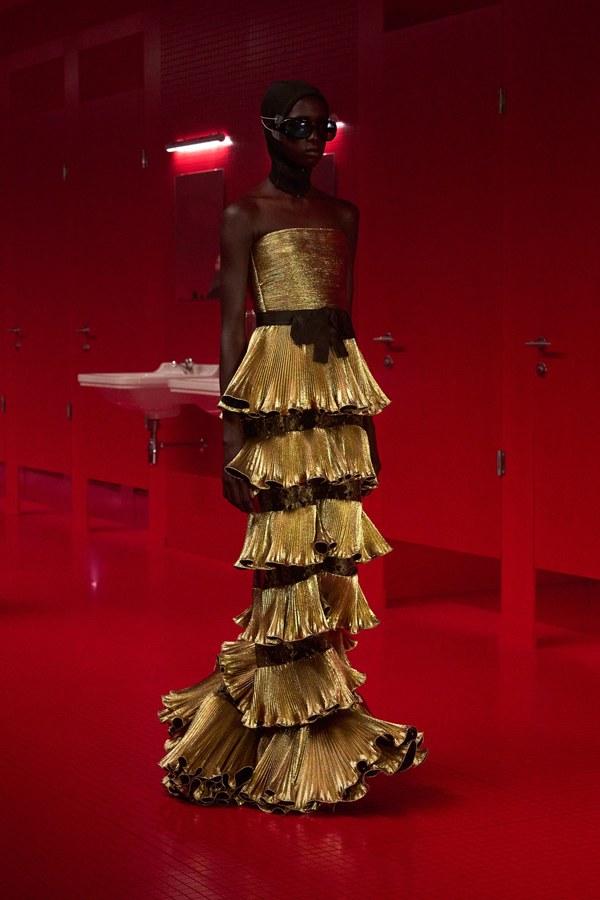 Valentino Fall 2025, look 58: strapless gown with six rows of gold pleated flounces