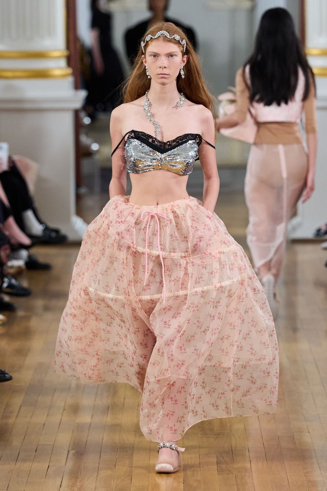 Simone Rocha Spring 2026, look 1: silver sequin bra top over a full pink floral tulle skirt of gathered tiers