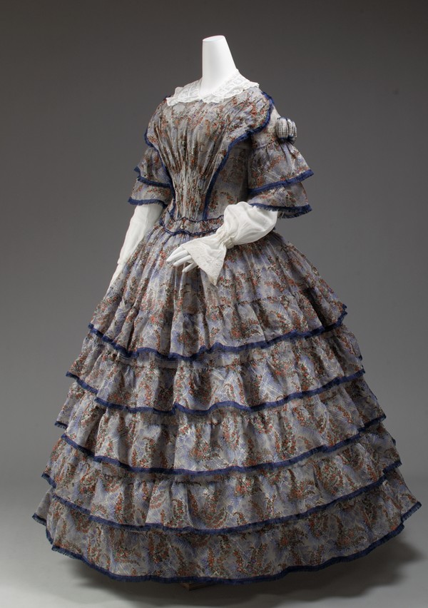 Silk dress, 1853–56, its skirt covered with five overlapping flounces over a crinoline