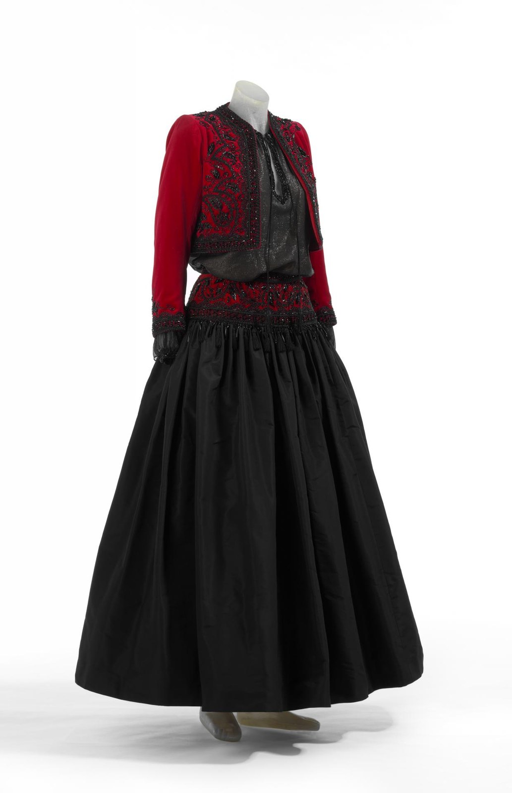 Yves Saint Laurent haute couture, Autumn-Winter 1976: Russian evening ensemble with a red velvet jacket and one very full black silk skirt gathered at the waist